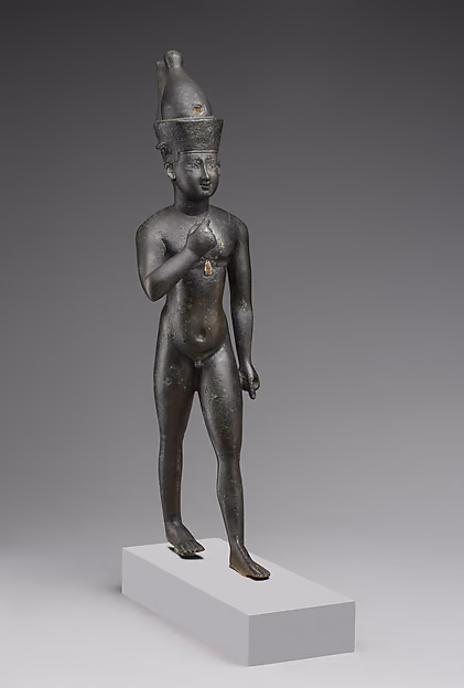 Horus the Child, a statuette in copper alloy. Here he wears a crown.